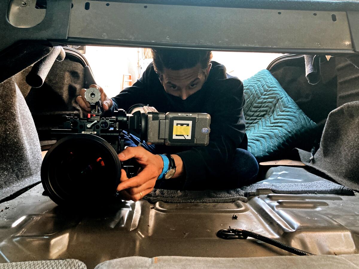 Cinematographer Carl Herse squeezes into a tight spot with his camera.