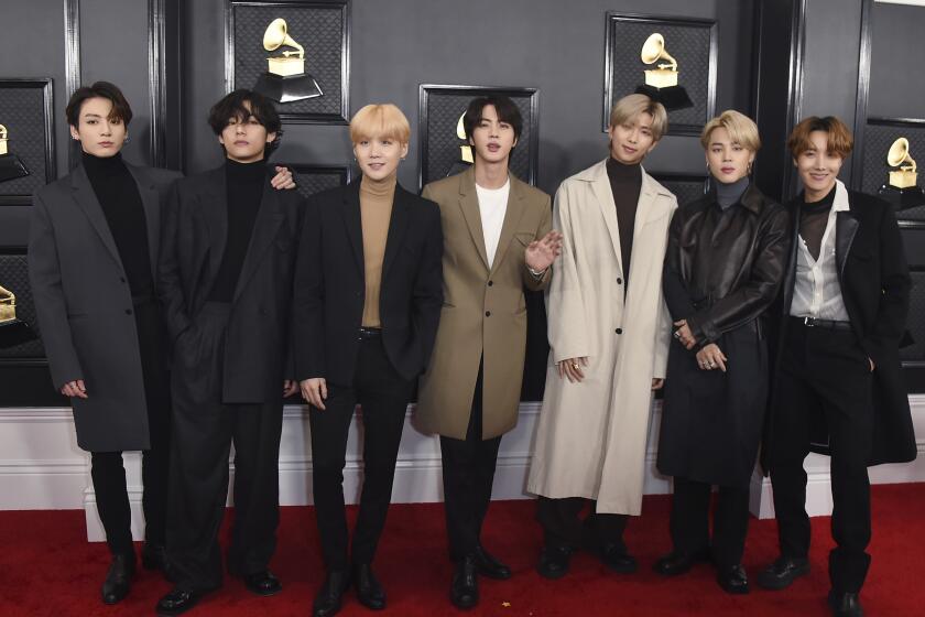 BTS posing in a line on the Grammys red carpet