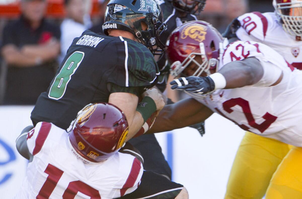 USC linebackers Dion Bailey (18) and Devon Kennard (42) sack Hawaii quarterback Taylor Graham during the Trojans' 30-13 rout of the Rainbow Warriors.