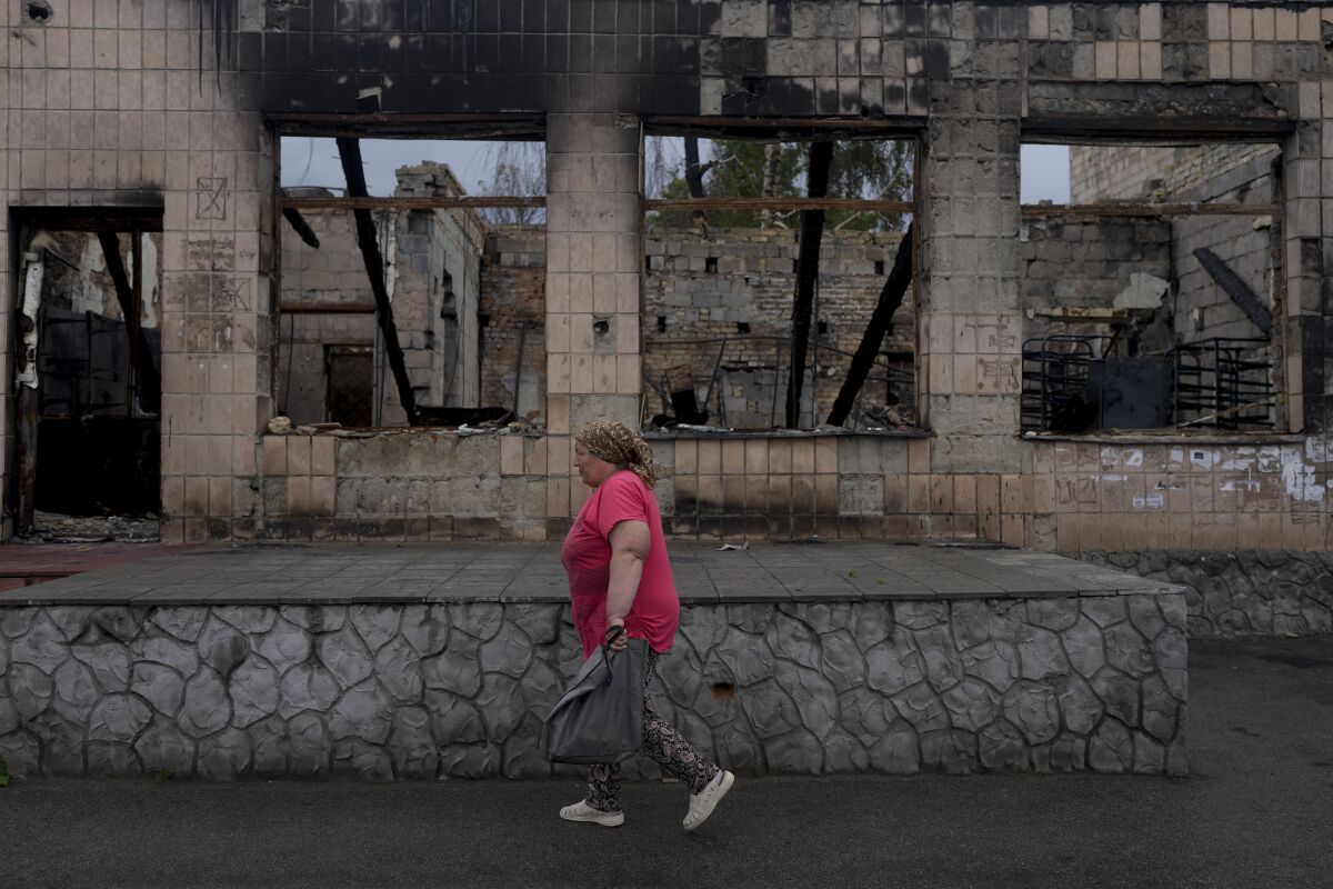 A local resident passes by shrapnel traces following Russian shelling in the town of Bakhmut.