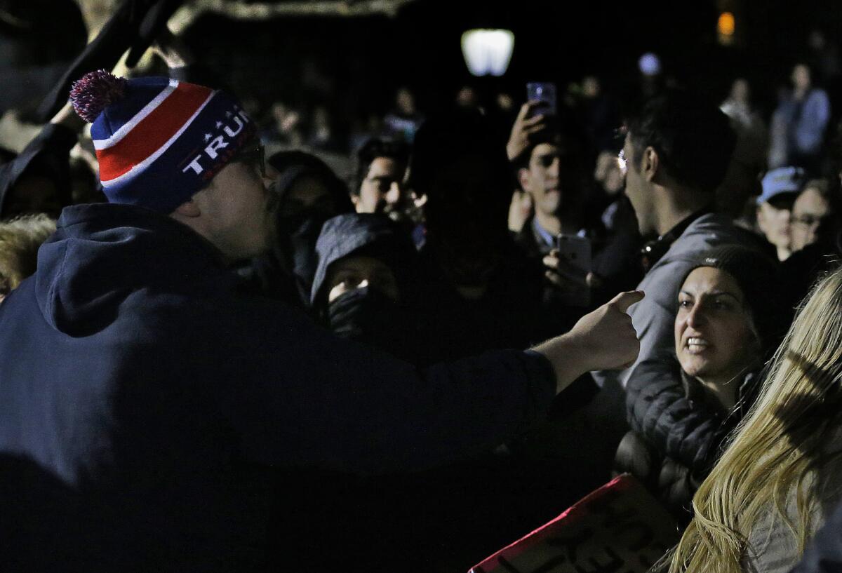 A Trump supporter argues with a protester during a rally against a scheduled appearance by Breitbart News editor Milo Yiannopoulos at UC Berkeley.