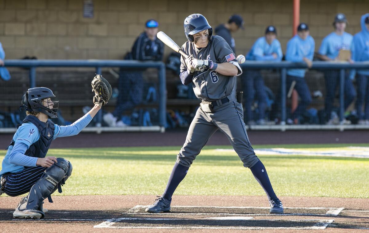 Newport Harbor's Ryan Williams gets hit by a pitch from Corona del Mar's Hogan Smith on Friday.