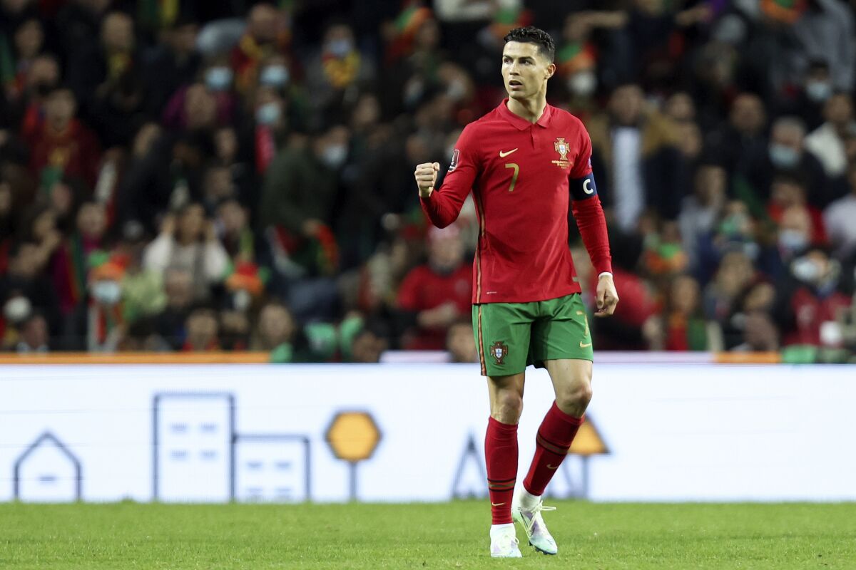 Portugal's Cristiano Ronaldo reacts after teammate Bruno Fernandes scored the opening goal during the World Cup 2022 playoff soccer match between Portugal and North Macedonia, at the Dragao stadium in Porto, Portugal, Tuesday, March 29, 2022. (AP Photo/Luis Vieira)