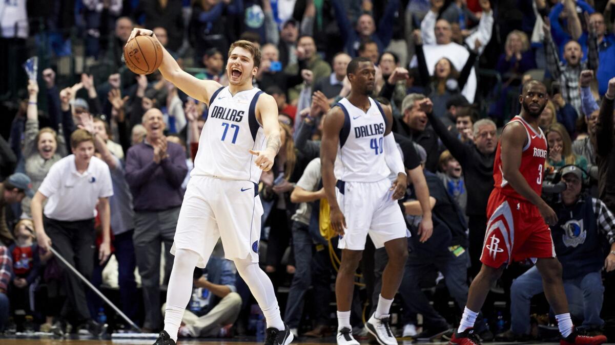 Dallas Mavericks forward Luka Doncic (77) celebrates after the Mavericks defeated the Houston Rockets 107-104.