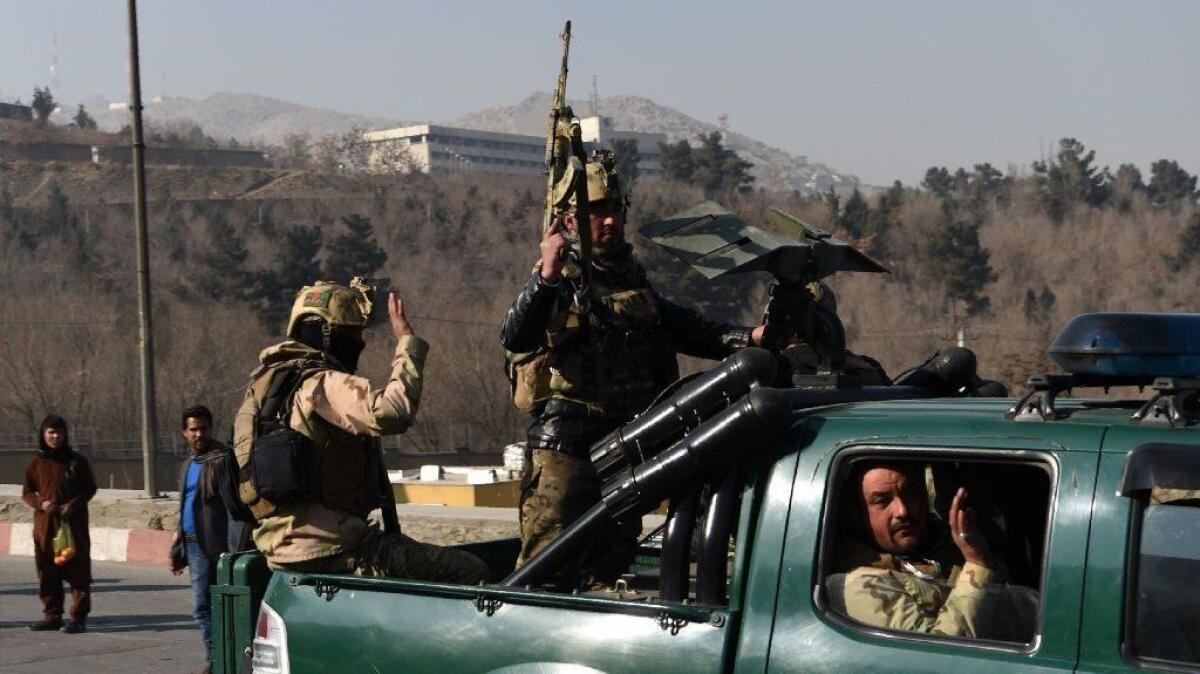 Afghan security personnel leave the Intercontinental Hotel after an attack in Kabul on Jan. 21.