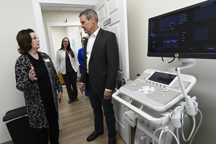 Portico Crisis Pregnancy Center executive Director Laura Messick, left, shows Tennessee Gov. Bill Lee one of two ultrasound examination rooms during a tour Jan. 26, 2022, in Murfreesboro, Tenn. The privately operated crisis pregnancy centers are funded with taxpayer dollars and steer women away from abortions but provide little if any health care services. The centers have opened in about a dozen states with restrictive abortion laws. (AP Photo/Mark Zaleski)