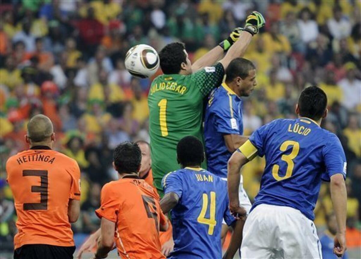 Brazil's Felipe Melo, top right, scores an own goal past Brazil goalkeeper Julio Cesar, top left, during the World Cup quarterfinal soccer match between the Netherlands and Brazil at Nelson Mandela Bay Stadium in Port Elizabeth, South Africa, Friday, July 2, 2010. (AP Photo/Martin Meissner)