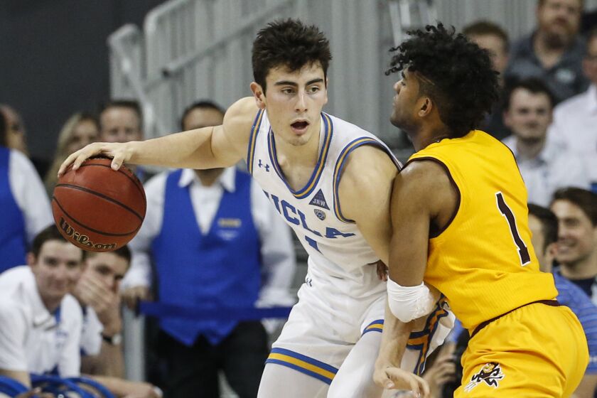 UCLA guard Jaime Jaquez Jr. (4) is defended by Arizona State guard Remy Martin (1) during an NCAA college basketball game Thursday, Feb. 27, 2020, in Los Angeles. (AP Photo/Ringo H.W. Chiu)