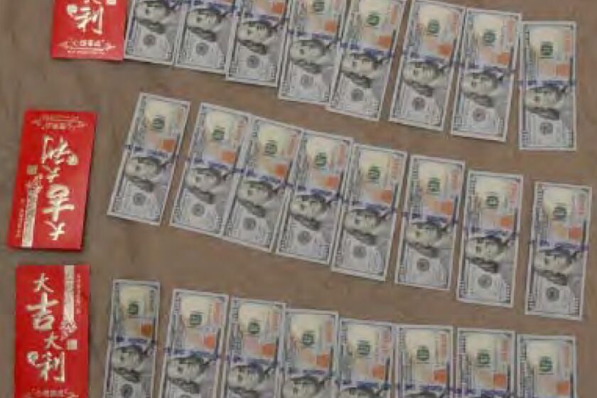 The photograph above documents cash found in L.A. City Councilman Jose Huizar's residence, including cash in red envelopes with Chinese characters.