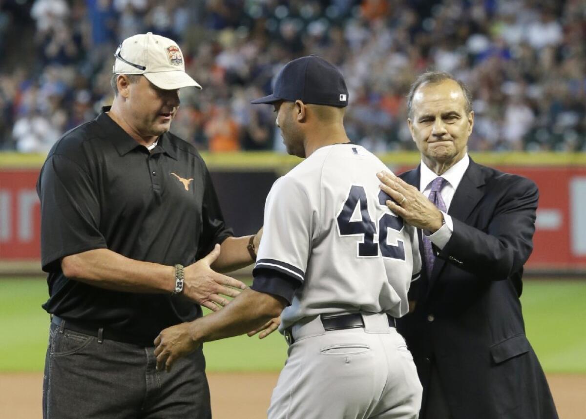 Mariano Rivera is greeted by Roger Clemens, left, and Joe Torre, right, before the final game of his career.