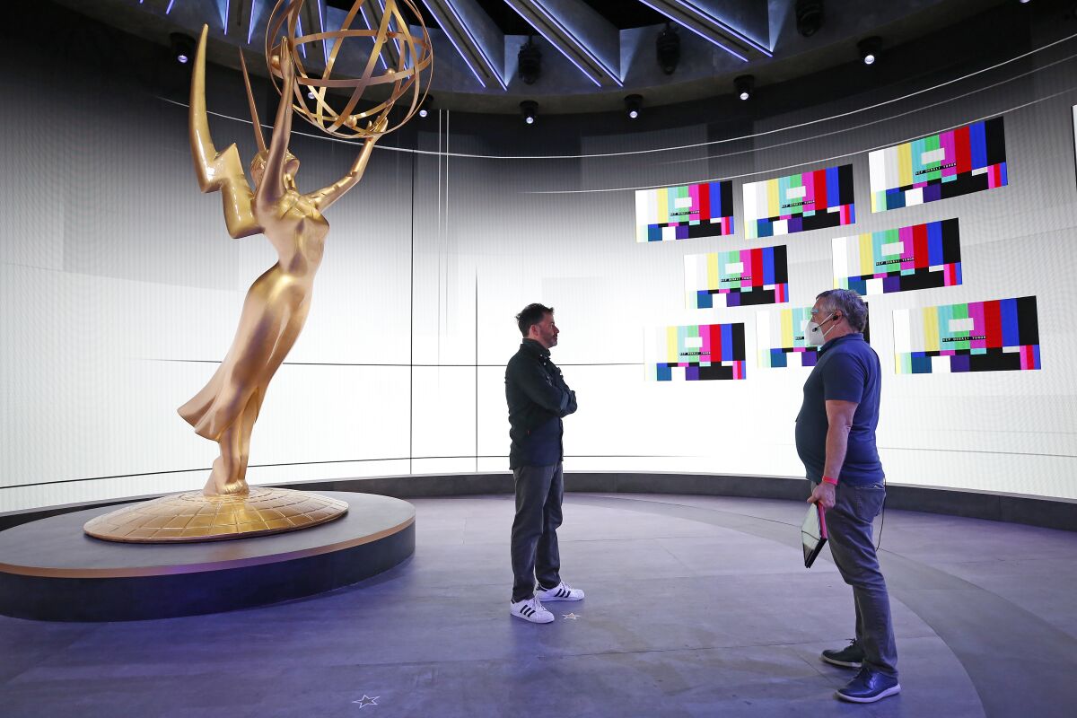 Emmy host Jimmy Kimmel talks with stage manager Gary Natoli, right, during rehearsals for the 72nd Emmy Awards.