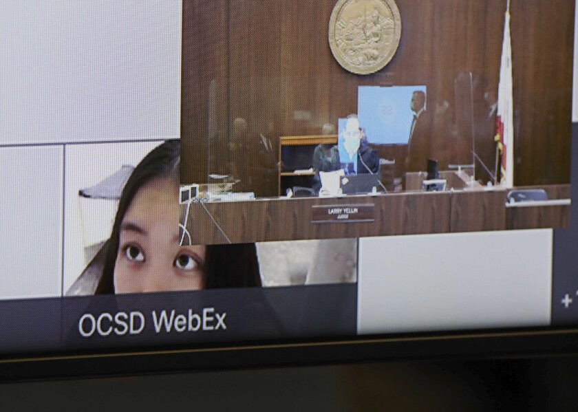 Wynne Lee, 23, is partially displayed on a video screen during a hearing at the Central Justice Center in Santa Ana