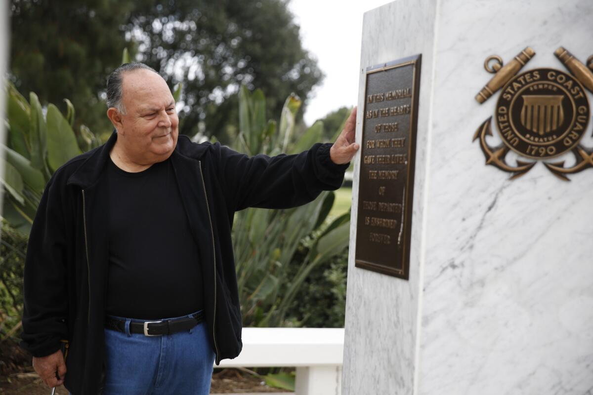 Ruben Valencia at the Vietnam war memorial at Rose Hills Memorial Park. (Dania Maxwell / Los Angeles Times)