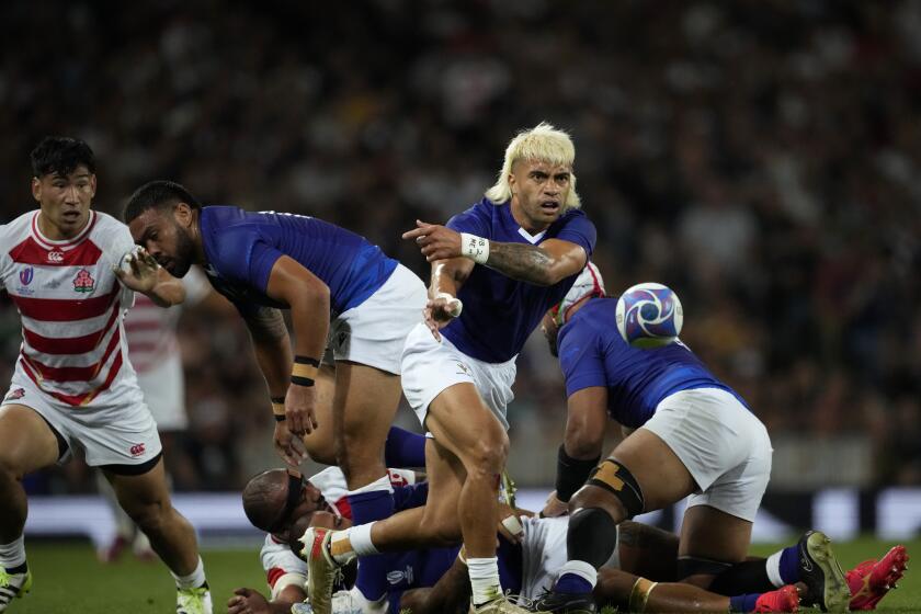 Samoa's Jonathan Taumateine passes the ball during the Rugby World Cup Pool D match between Japan and Samoa, at the Stadium de Toulouse in Toulouse, France, Thursday, Sept. 28, 2023. (AP Photo/Christophe Ena)