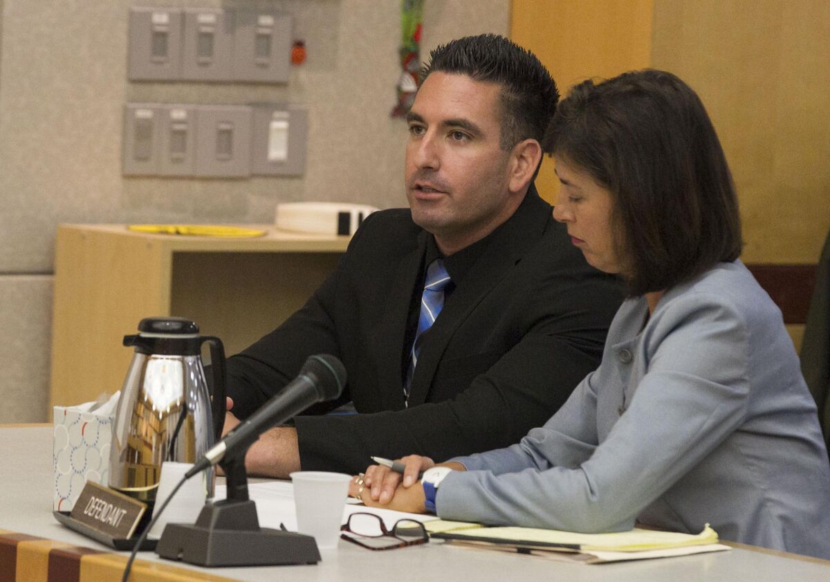 Seated with his attorney Gretchen Von Helms (right), former San Diego County sheriff's deputy Richard Fisher pleaded guilty to four felonies and three misdemeanors stemming from charges related to misconduct towards 16 women while on duty. The plea was accepted by Superior Court Judge Daniel B. Goldstein in Vista on Monday.