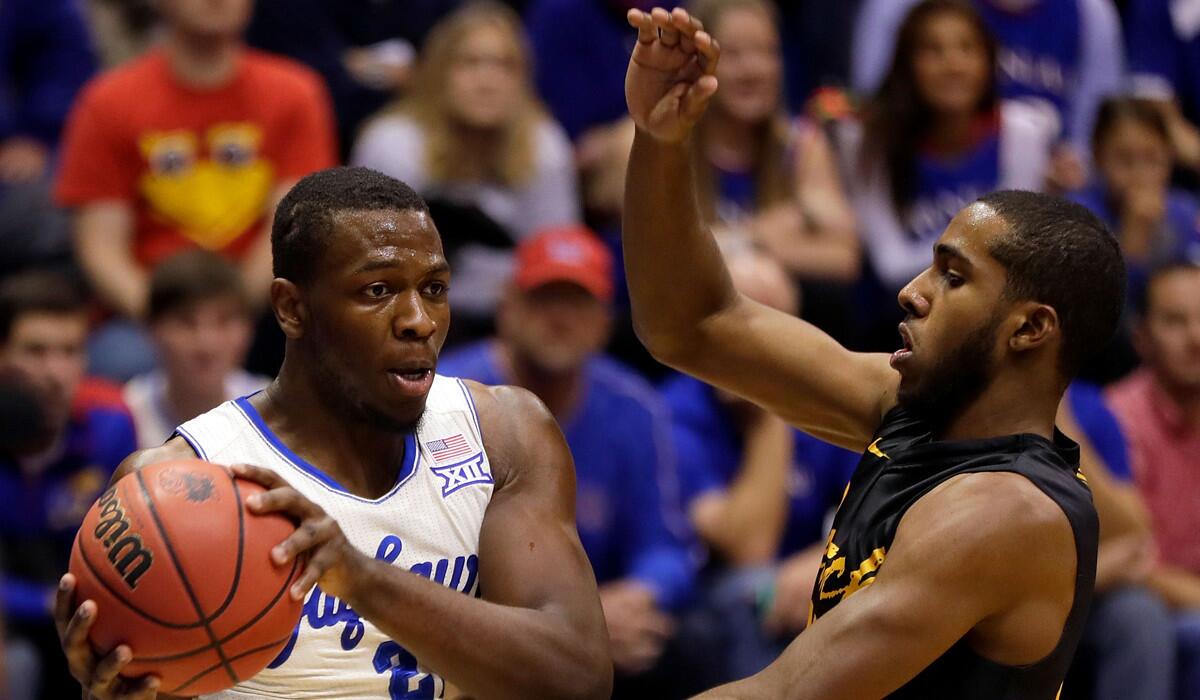 Kansas' Dwight Coleby, left, controls the ball as Long Beach State's Barry Ogalue defends during a game Tuesday.