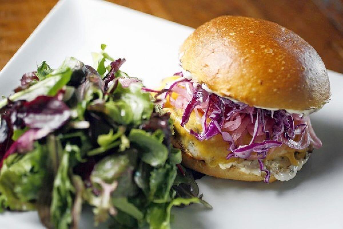 Four Cafe patrons can sample a grilled mahi mahi burger with pickled red onions, cheddar cheese and tartar slaw and served on a brioche bun.
