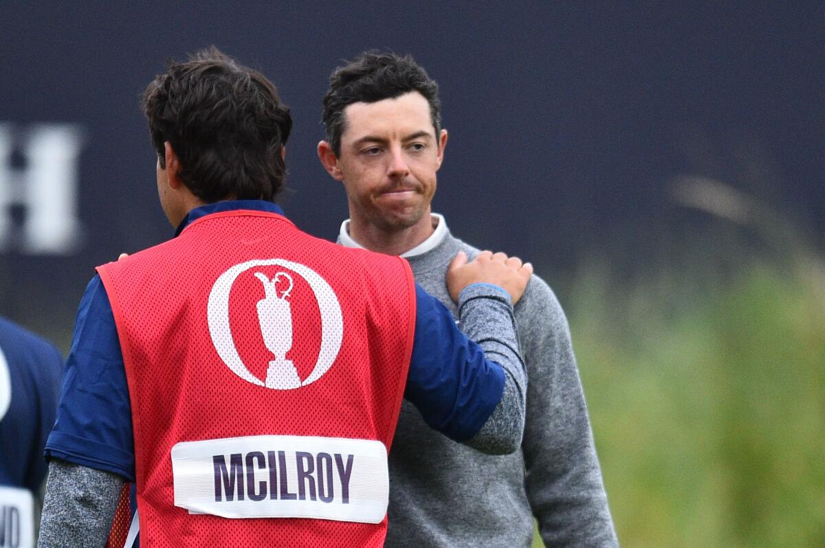 Northern Ireland's Rory McIlroy is consoled by his caddy at the 18th green.