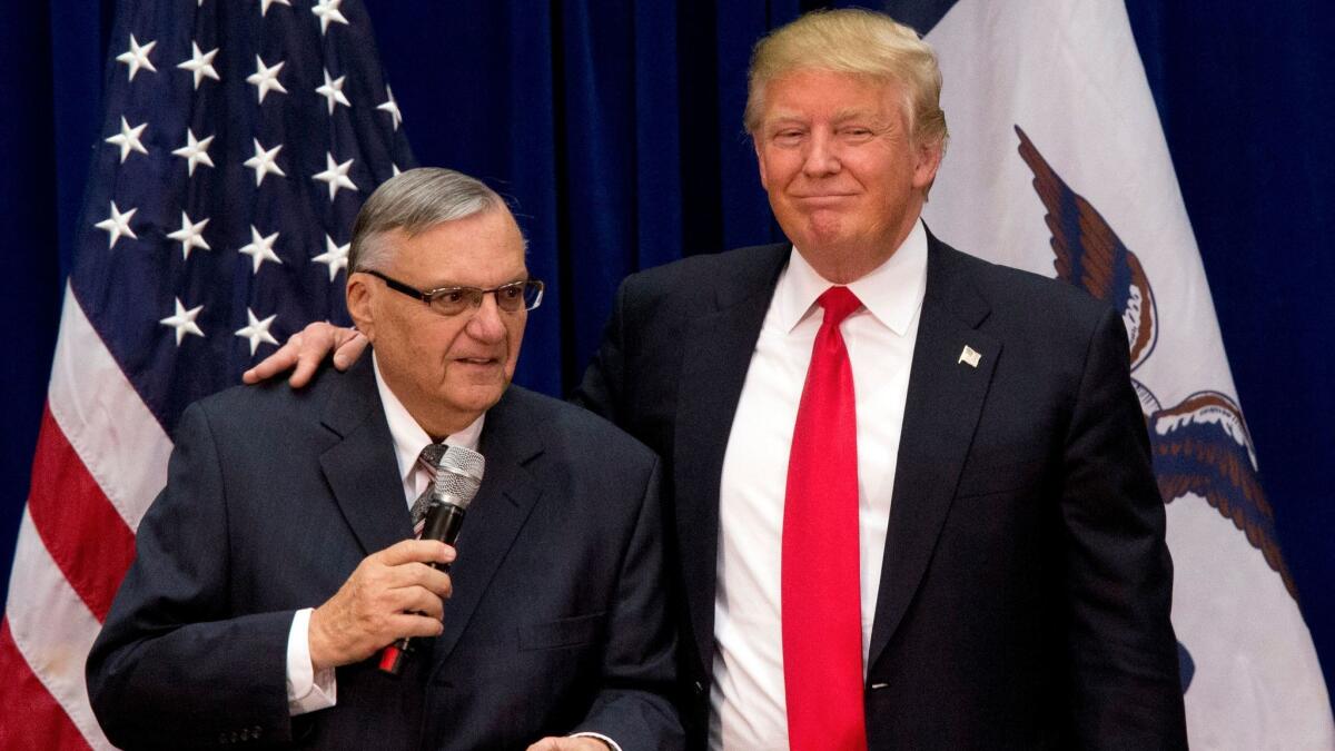 Joe Arpaio, left, the former sheriff of Maricopa County in Arizona, joins then-presidential candidate Donald Trump at a campaign event in Marshalltown, Iowa, on Jan. 26, 2016.