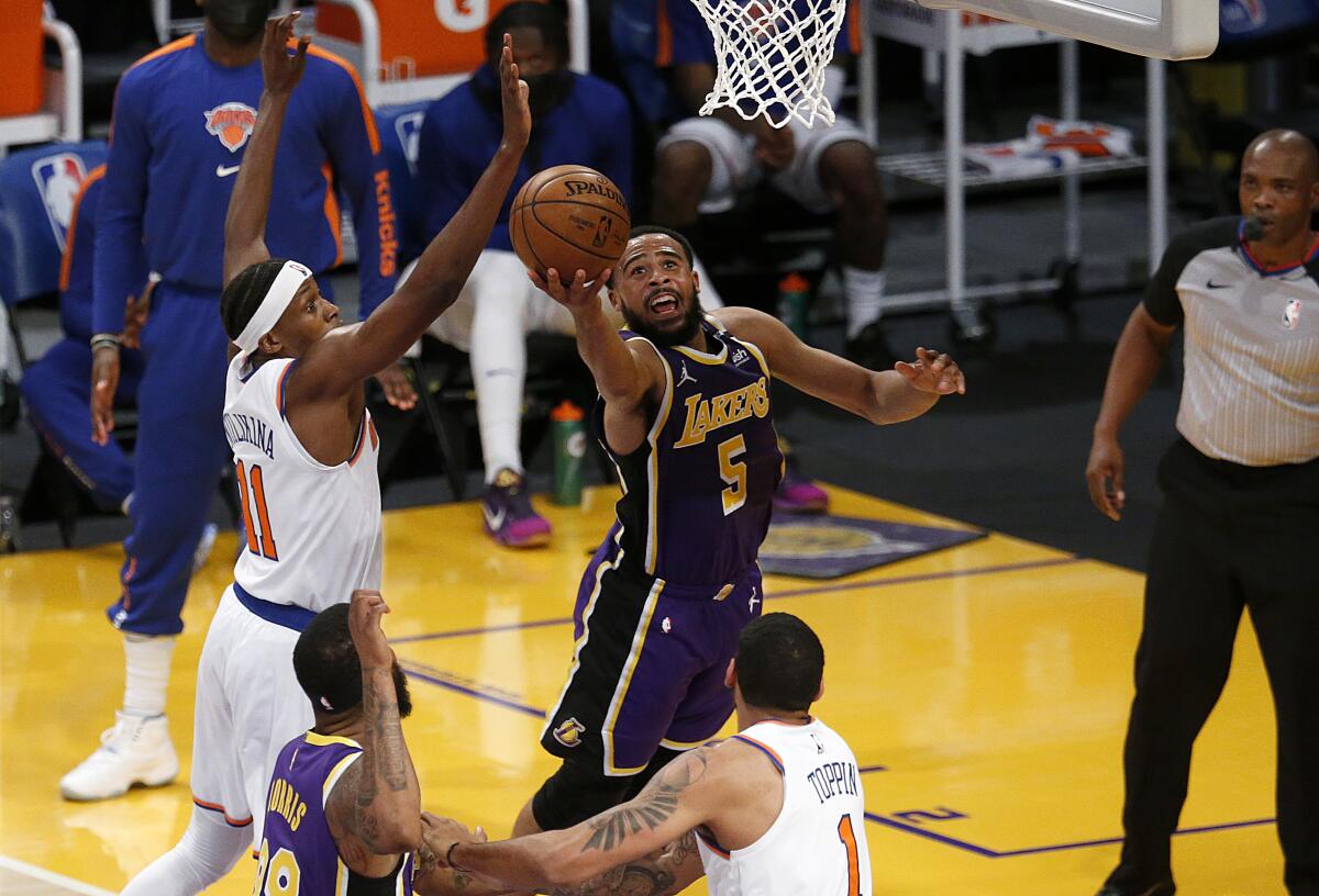 Lakers guard Talen Horton-Tucker puts up a shot in front of New York Knicks guard Frank Ntilikina.
