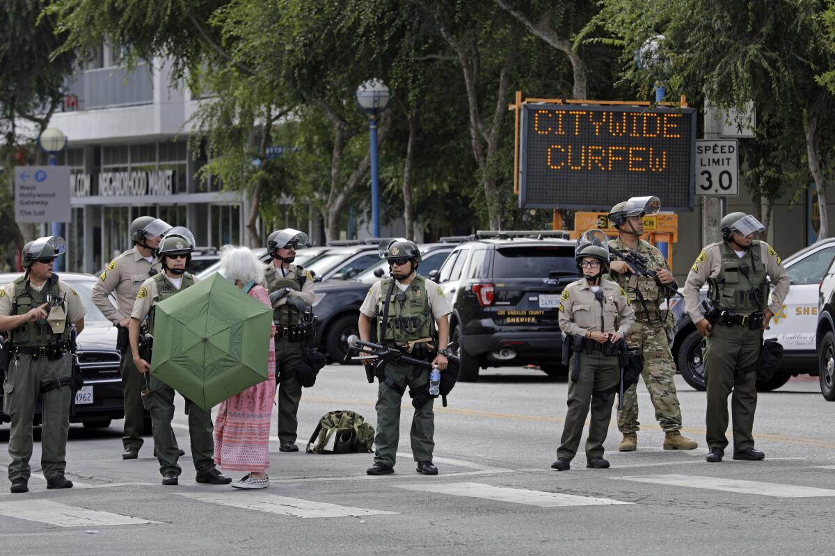 A sign in West Hollywood flashes curfew warnings