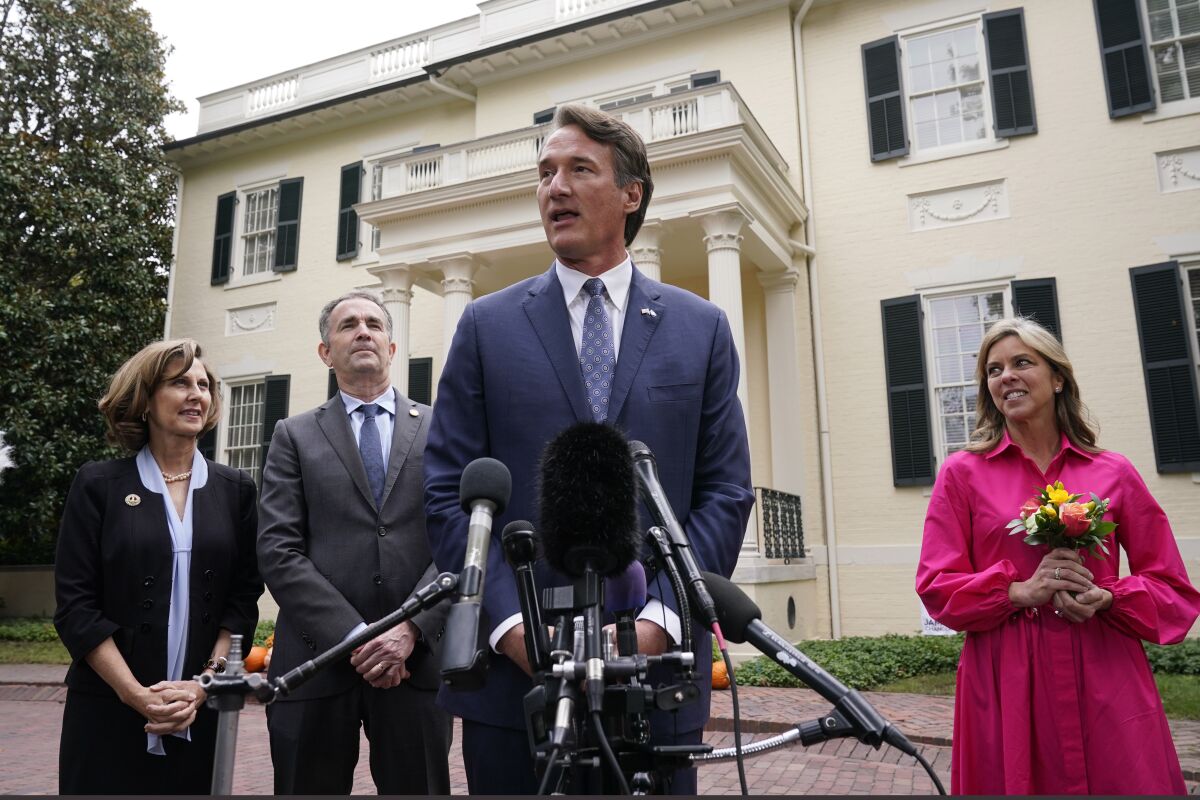 Virginia Gov.-elect, Glenn Youngkin, second from right, speaks to the media as Virginia Gov. Ralph Northam, second from left, Suzanne Youngkin, right, and Pam Northam look on after a transition meeting outside the Governors Mansion at the Capitol in Richmond, Va., Thursday, Nov. 4, 2021.