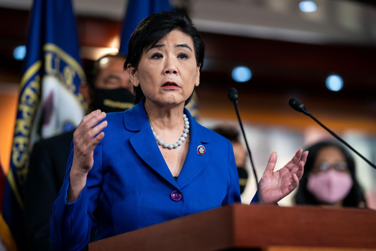 Rep. Judy Chu speaks at a lectern with two microphones
