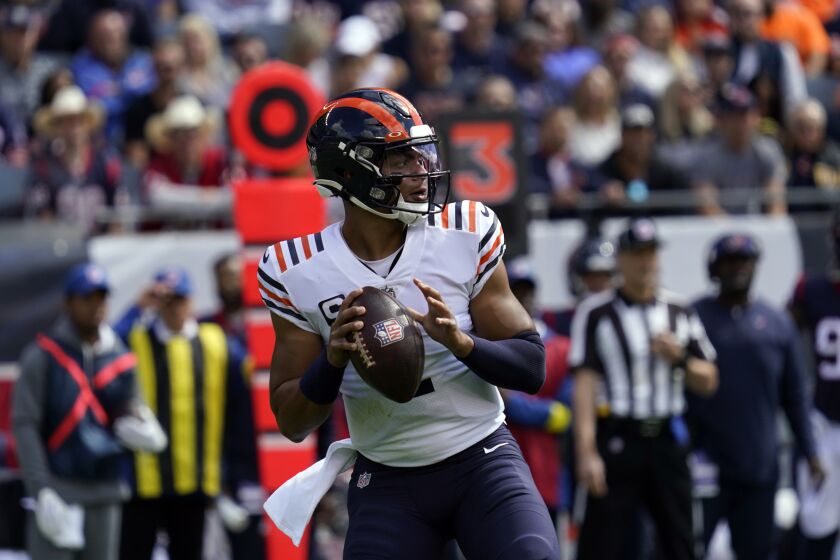 Chicago Bears quarterback Justin Fields looks to throw a pass against the Houston Texans during the first half of an NFL football game Sunday, Sept. 25, 2022, in Chicago. (AP Photo/Nam Y. Huh)