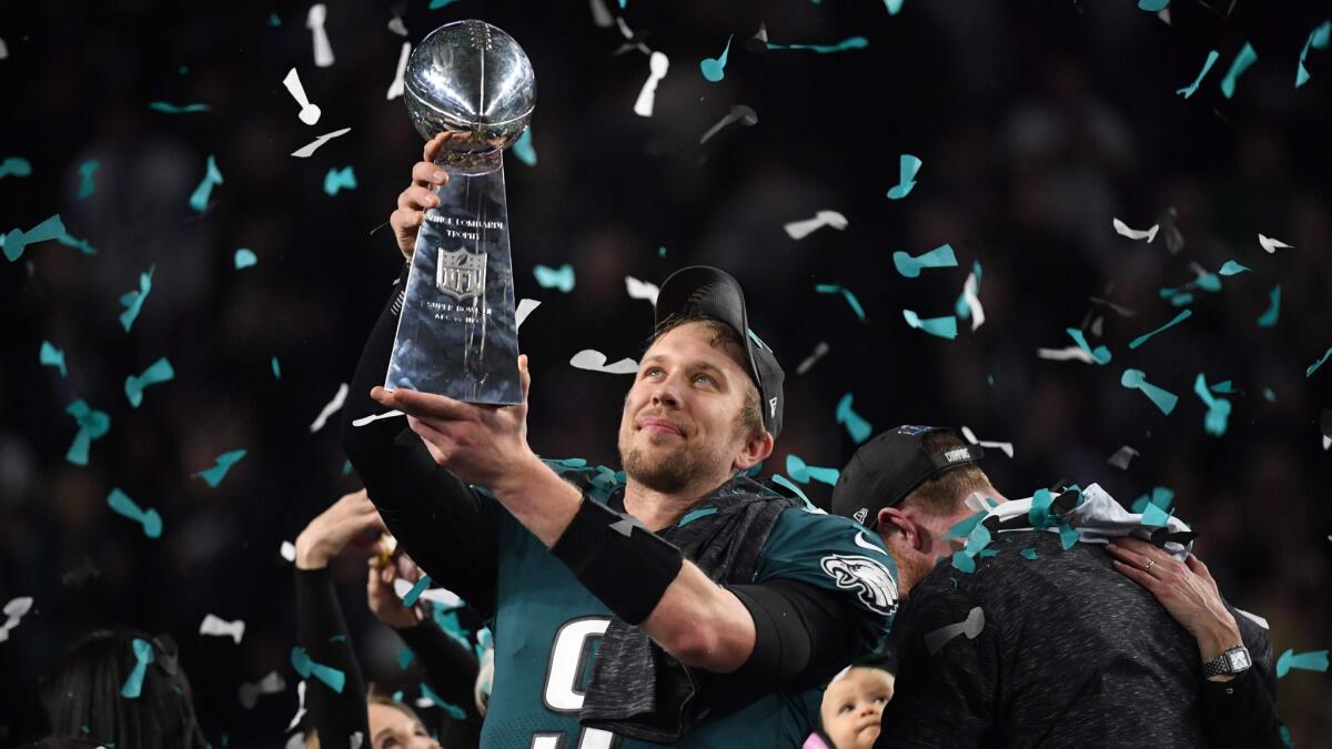 Philadelphia quarterback Nick Foles lifts the Lombardi Trophy aloft after leading the Eagles to a 41-33 victory over New England in Super Bowl LII.