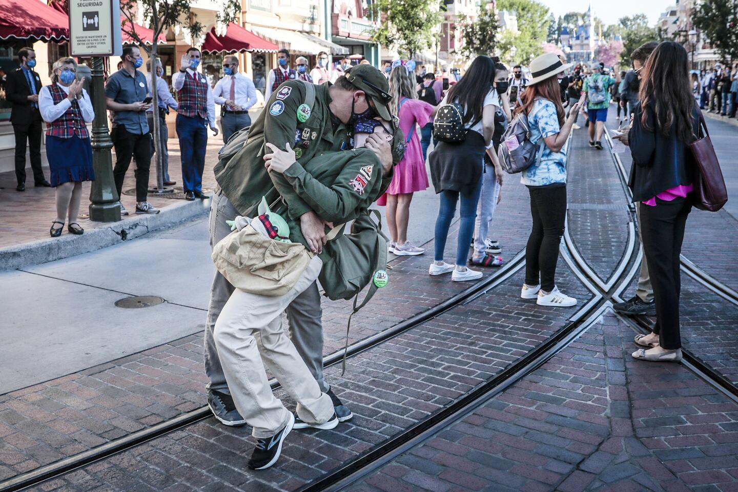ANAHEIM CA APRIL 30, 2021 - A couple recreate the famous Alfred Eisenstaedt V-J Day photo inside Disneyland as the theme park reopens for the first time in more than a year on Friday, April 30, 2021. The reopening of Disneyland, which was shut down in March of last year due to the COVID-19 pandemic. ``is a monumental day for Anaheim,'' city spokesman Mike Lyster said.(Robert Gauthier / Los Angeles Times)