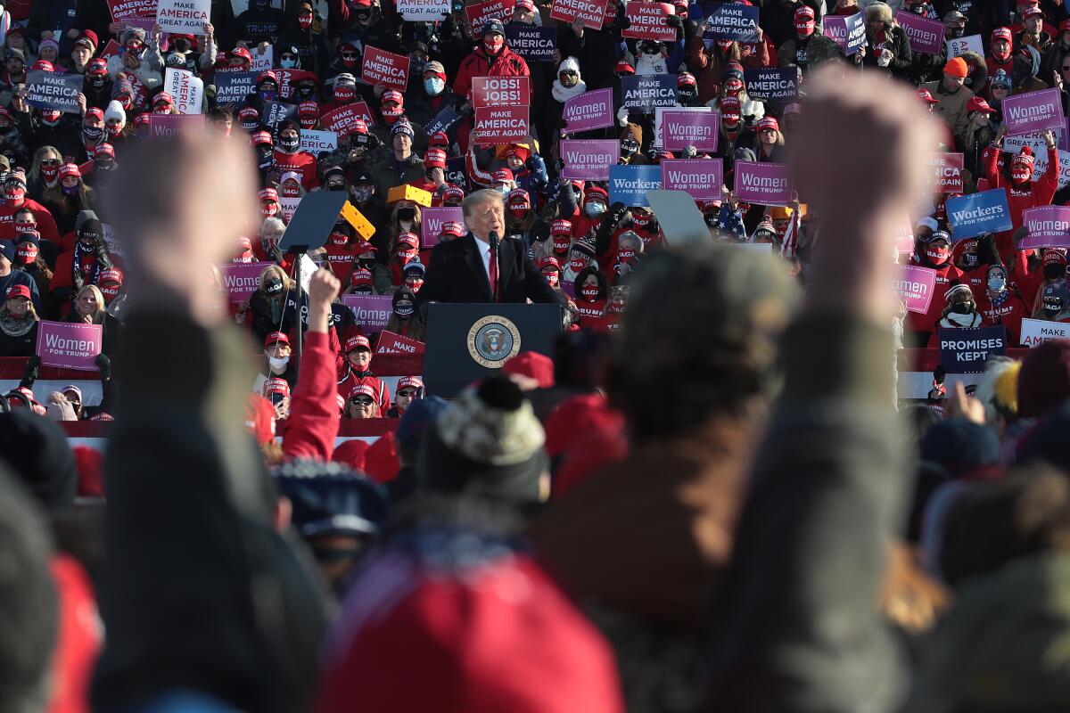 President Donald Trump speaks during a crowded campaign rally.