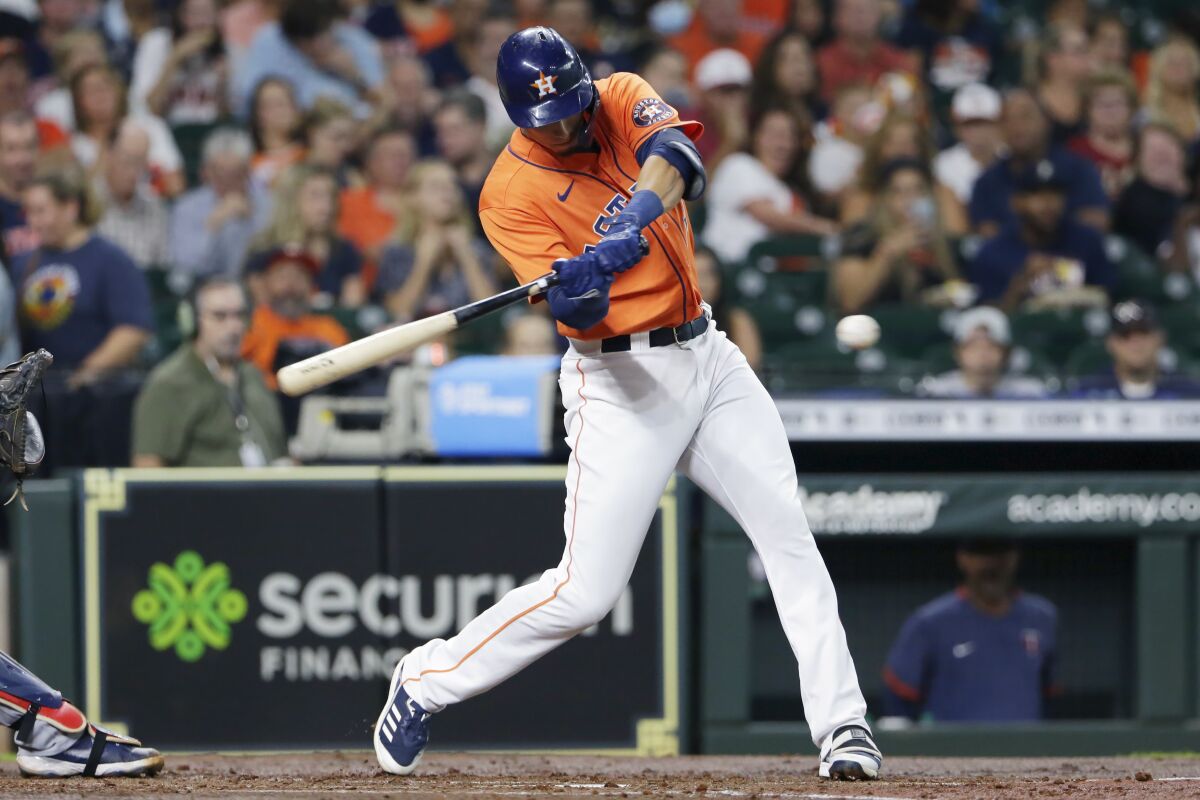 Houston Astros' Taylor Jones swings on a two-run home run against the Minnesota Twins during the second inning of a baseball game Friday, Aug. 6, 2021, in Houston. (AP Photo/Michael Wyke)