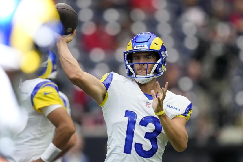 Los Angeles Rams quarterback Stetson Bennett (13) warms up before a preseason.