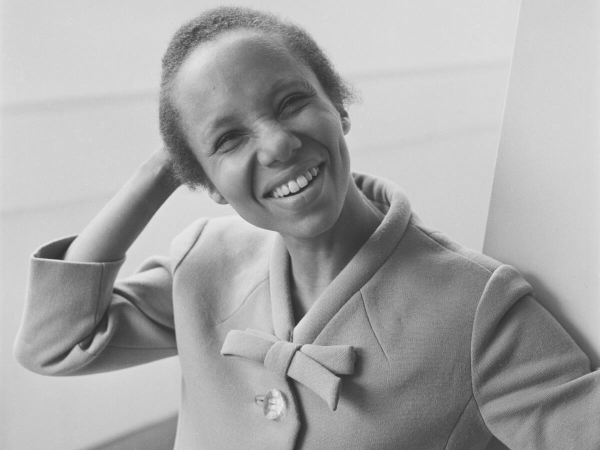 Playwright Adrienne Kennedy is shown smiling in a vintage black and white photo.