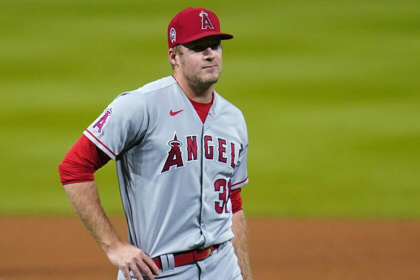 Los Angeles Angels relief pitcher Ty Buttrey reacts after giving up a solo home run to Colorado Rockies' Ryan McMahon.