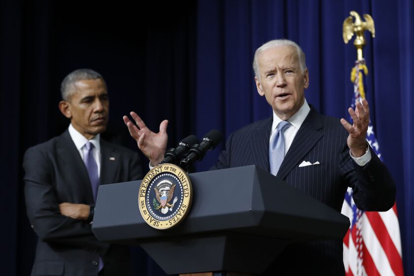 President Barack Obama listens as Vice President Joe Biden speaks in the South Court Auditorium in the Eisenhower Executive Office Building on the White House complex in Washington, Tuesday, Dec. 13, 2016, before the president signed the 21st Century Cures Act. (AP Photo/Carolyn Kaster)