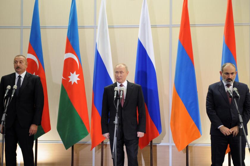FILE - Russian President Vladimir Putin, center, Azerbaijan's President Ilham Aliyev, left, and Armenia's Prime Minister Nikol Pashinyan attention a news conference during their meeting in the Bocharov Ruchei residence in the Black Sea resort Sochi, Russia, on Nov. 26, 2021. A senior U.N. official urged the international community Tuesday, Dec. 20, 2022, to prevent Armenia and Azerbaijan from resuming their conflict over the disputed Nagorno-Karabakh region as the two countries accused each other of violating a Russian-brokered peace agreement.(Mikhail Klimentyev, Sputnik, Kremlin Pool Photo via AP, File)