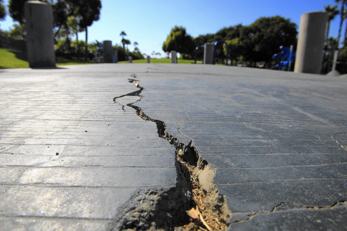 A long crack splits the sidewalk at Discovery Well Park in Huntington Beach, which is located on top of the Newport-Inglewood fault.