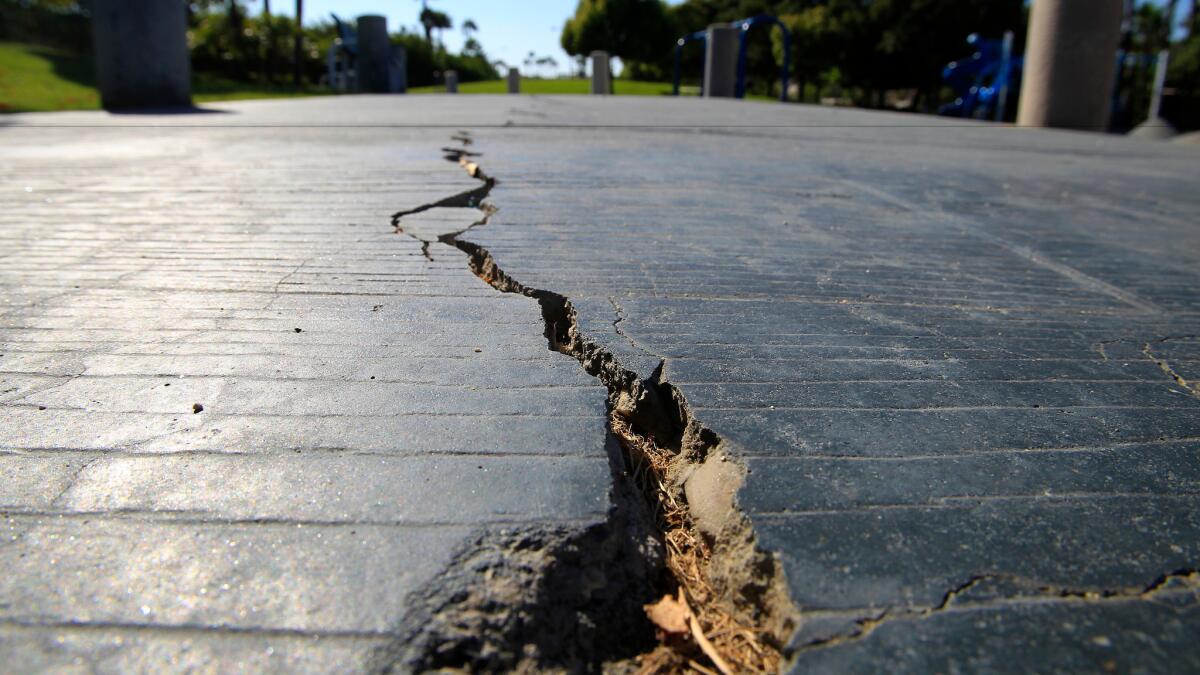 A crack split the sidewalk in 2014 at Discovery Well Park in the Seacliff area of Huntington Beach, on the Newport-Inglewood fault.