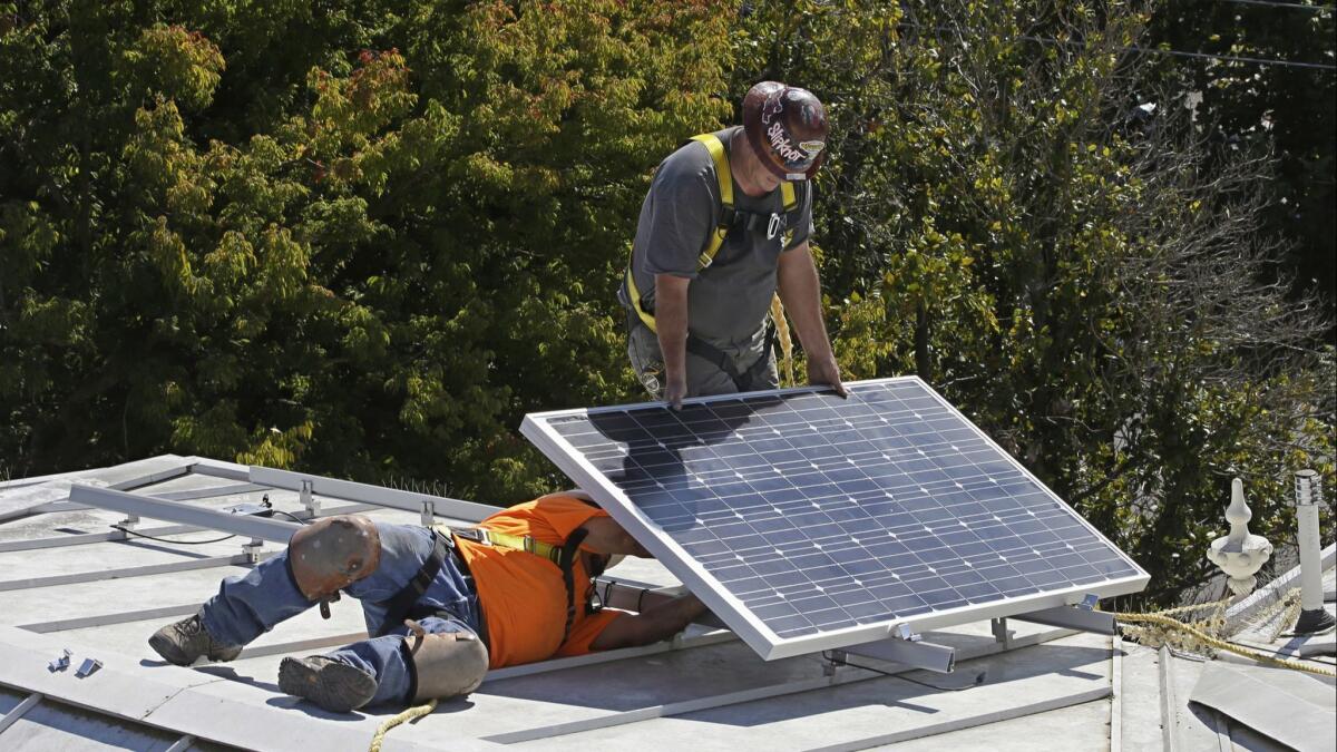 A solar panel is installed on the roof of the Old Governor's Mansion State Historic Park in Sacramento, Calif.