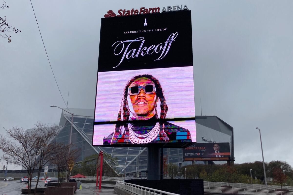 A lighted billboard outside an Atlanta arena shows a picture of the late rapper Takeoff at his memorial service