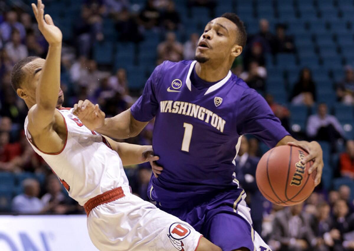 Washington guard Darin Johnson, a freshman from Sacramento who is driving against Utah's Brandon Taylor during a Pac-12 tournament game Wednesday, could be part of the Huskies' team that travels to China to open the 2015-16 season.
