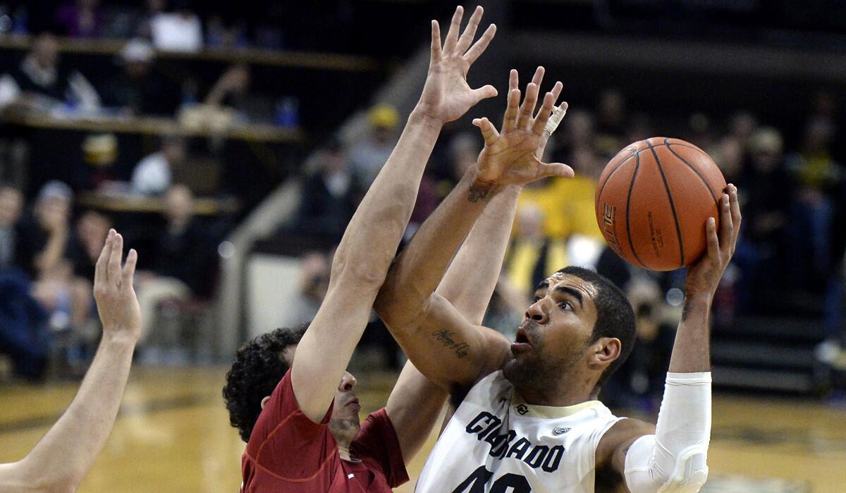 Colorado's Josh Scott, right, takes a shot over Stanford's Josh Sharma during the game on Wednesday.