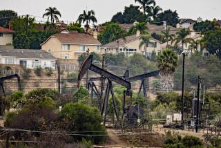 Los Angeles, - September 25: Homes sit in the shadows of the Inglewood oil field as Governor Gavin Newsom signs legislation related to oversight of oil and gas wells, and community protections on Wednesday, Sept. 25, 2024 in Los Angeles, . (Jason Armond / Los Angeles Times)