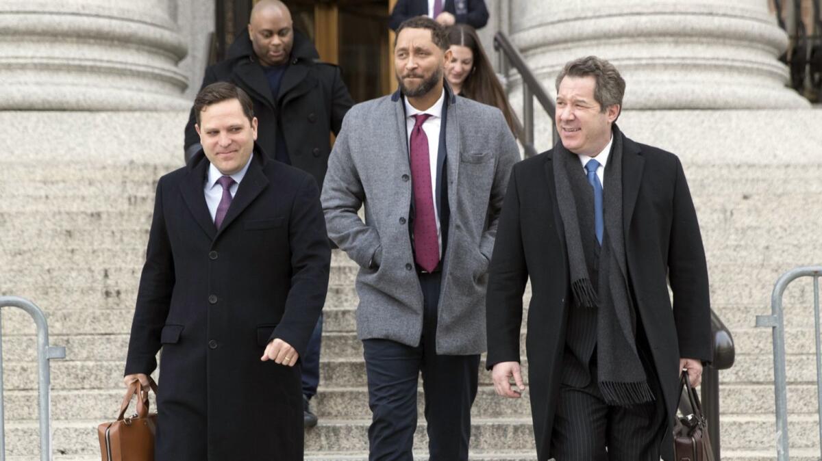 Former USC assistant basketball coach Tony Bland, center, leaves Manhattan federal court in New York on Jan. 2. Bland’s attorney is arguing his client shouldn’t have to serve prison time.