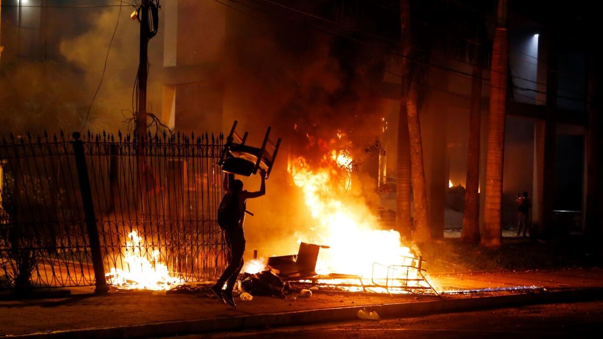 A fire is set outside the Congress building in Asuncion, Paraguay, during clashes between police and protesters opposing a constitutional amendment that would allow the election of a president to a second term.
