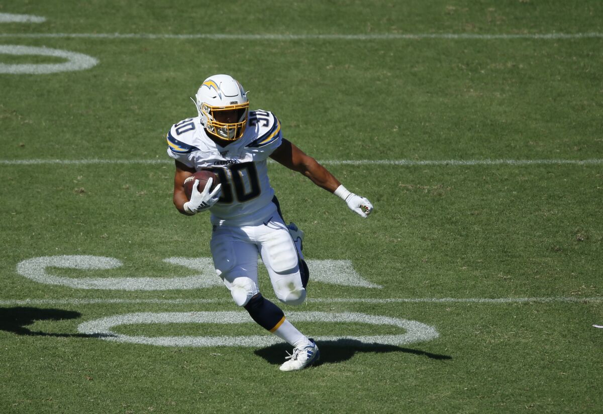Chargers running back Austin Ekeler runs the ball against the Indianapolis Colts in Carson on Sept. 8, 2019.