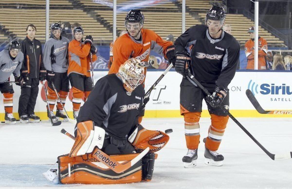 Ducks goalie Frederik Andersen blocks a Kyle Palmieri shot during a Friday practice in on the ice at Dodger Stadium ahead of the team's matchup Saturday with the Kings as part of the NHL's Stadium Series.