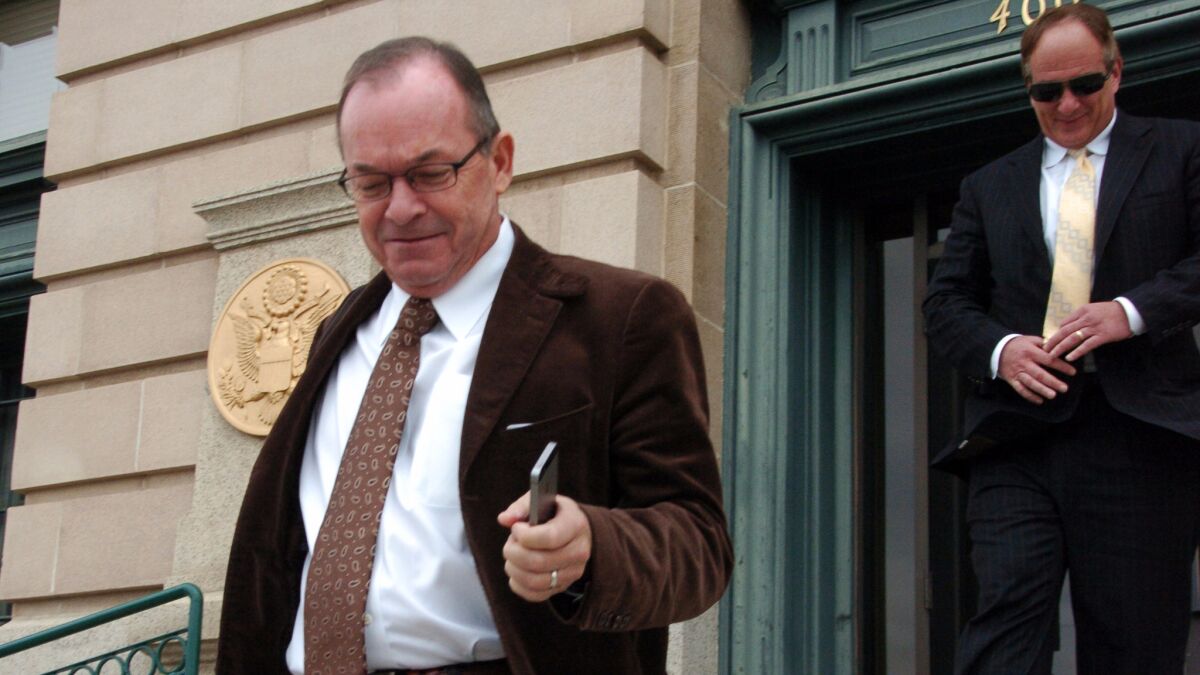 Tim Blixseth, left, leaves the U.S. courthouse in Butte, Mont., after facing questions about his finances in November 2014.