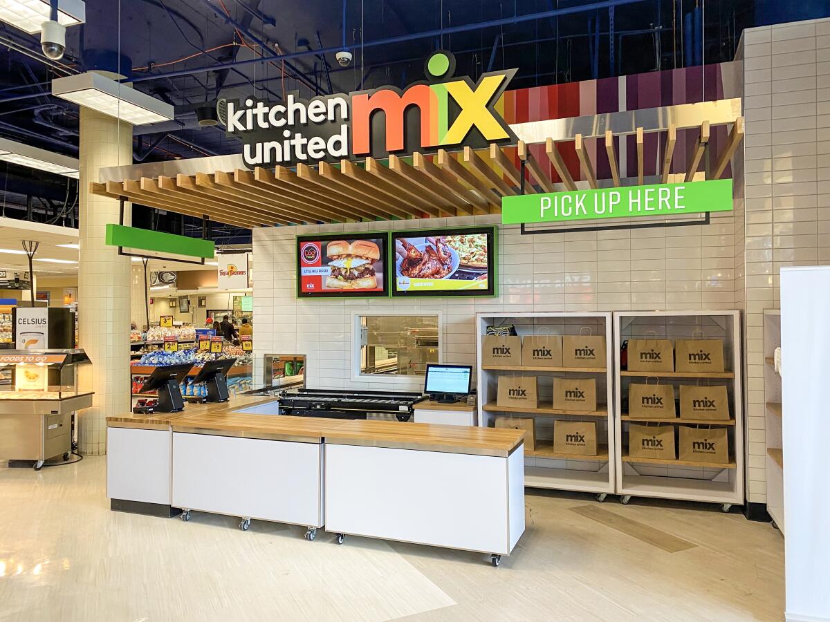 The Kitchen United Mix ordering and pickup counter within Ralphs supermarket.